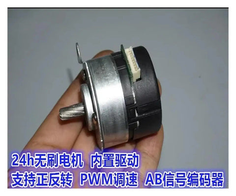 Close-up of high efficiency brushless servo motor with built in drive 9V to 24V DC PWM speed regulation, held in hand.