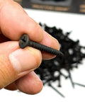 Pro Grade Drywall Screws For Light Gauge Steel Studs Size Six By One And A Quarter Inch fine thread being held, showcasing Phillips bugle head.