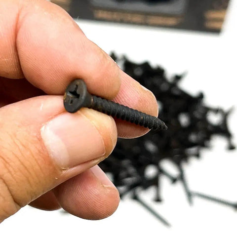 Pro Grade Drywall Screws For Light Gauge Steel Studs Size Six By One And A Quarter Inch fine thread being held, showcasing Phillips bugle head.