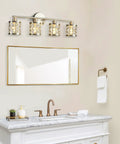4 Light Bathroom Vanity Light In Brushed Nickel With Cylinder Crystal Shades over a mirror, modern wall lights for luxurious glow.