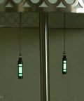 Embrite Glow Fob With Green Embrite Pellet, Aircraft-Grade Aluminum Keychain Accessory hanging under a table
