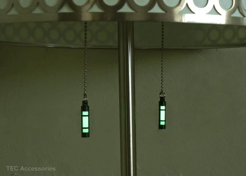 Embrite Glow Fob With Green Embrite Pellet, Aircraft-Grade Aluminum Keychain Accessory hanging under a table
