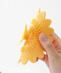 Floor Drain Plug Shower Bathtubs Drain Covers, Flower, White shown in hands, silicone hair catcher design, 12.6cm diameter.