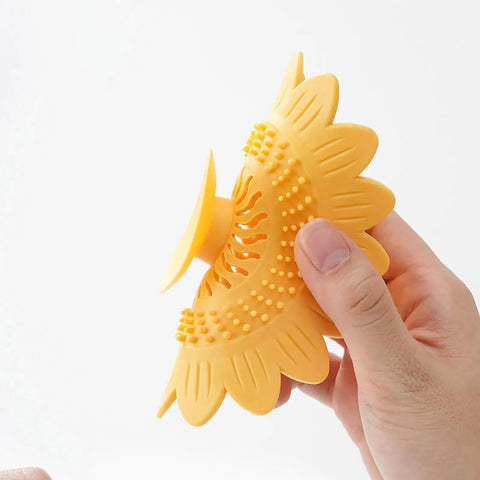 Floor Drain Plug Shower Bathtubs Drain Covers, Flower, White shown in hands, silicone hair catcher design, 12.6cm diameter.