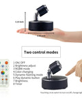 LED Spotlight Battery Operated Light With Remote Control Dimmable Mini Accent Lighting shown with remote control and hand for size.