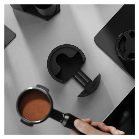 Adjustable Aluminum Portafilter Tamping Base With Durable 51 53 58mm Stand For Quick Shot Prep, seen with espresso portafilter on counter.