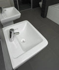 Bathtub Stopper Plug for 42-44mm Holes, Silicone Steel White displayed near modern square sinks with chrome faucets.