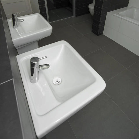 Bathtub Stopper Plug for 42-44mm Holes, Silicone Steel White displayed near modern square sinks with chrome faucets.