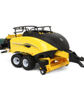 1/32 Scale New Holland Big Baler 340 Plus Diecast Model with six square bales and free rolling wheels, side view.