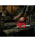 Using Badass Heavy Duty Cordless Grease Gun Kit on equipment with a flexible hose and high output flow rate.