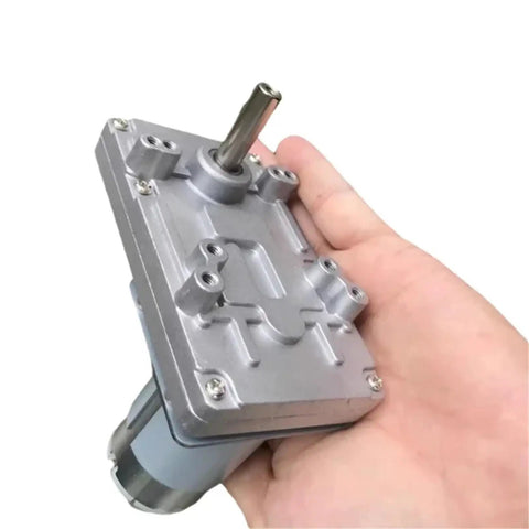 Badass 555 Size Dc Motor Paired With A Precision Steel Worm Gear Reducer 12 Volt And 24 Volt Drive Units held in hand.