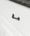 Oil Rubbed Bronze Rounded Foot Cabinet Pulls 4.63 Inches Long With 3 Inch Center, 1 Inch Projection, on white drawer
