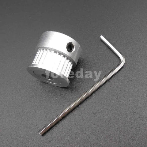 Heavy Duty Alloy GT2 Synchronous Timing Pulley Five Pack With 25 Teeth 6mm Wide And 8mm Bore alongside an Allen wrench on a black surface.