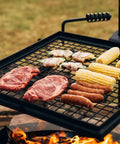 Adjustable Swivel Grill Grate For Open Fire Cooking With Spike Pole Steel Mesh Wire Grate showing meats and corn on grill.