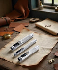 Pro Grade Heavy Duty Steel Leather Hole Punch Set Three Piece Grommet Punch Kit With Sizes One Quarter Inch Three Eighths Inch And One Half Inch for leather crafting on a wooden table.