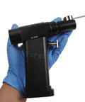 Handheld Knockout Veterinary Orthopedic Mini Bone Saw With Micro Oscillating Drill for precise animal surgeries in gloved hand.