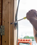 Demolition Screwdriver Set For Tough Jobs Pry Ready in use on wooden frame, showing leverage and grip on electrical box.