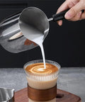 Pouring milk from Stainless Steel Turkish Coffee Pot And Moka Style Saucepan For Brewing Coffee Melting Chocolate Heating Milk And Sauces 350Ml 600Ml 900Ml With Pouring Spout Durable Kitchen Vessel For Everyday Kitchen Hustle