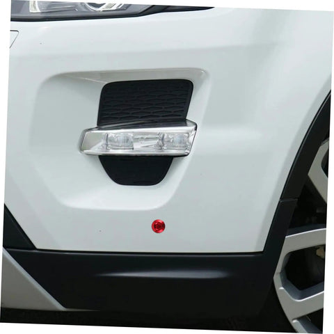 Zoomed view of car bumper showing stainless steel quick release latch system for engine bay access with red accent