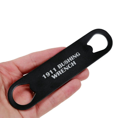 Hand holding 1911 Barrel Bushing Wrench Black Anodized Aluminum Handle with Black Oxide Finish for gunsmithing and maintenance