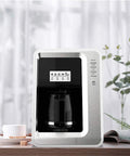 Fully Automatic Bean To Cup Coffee Maker With Built In Grinder Removable Reservoir And Smart Thermal Insulation on countertop with cup.