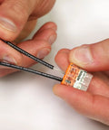 Hands using Push-In Wire Connector Kit With 45 Wall Nuts Case, Quick-Connect Splice For Solid And Stranded Conductors, Assorted 2773-402 To 2773-408