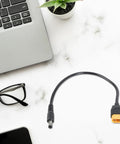 Male to DC5.5x2.1mm or 2.5mm 5A Charging Cable 20AWG Heavy Duty Power Lead on marble desk next to laptop and glasses