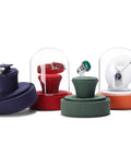 Colorful velvet jewelry holders with glass domes and rings, showcasing multiple display options for various accessories.