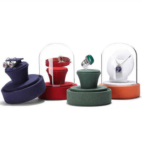 Colorful velvet jewelry holders with glass domes and rings, showcasing multiple display options for various accessories.