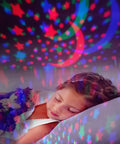 Girl sleeping under Pink Star Projector Night Light For Kids Room Decor With A Cozy Dreamy Vibe For Girls Ages 3 4 5 6 7 8 9 10 Projects Up To 15 Feet Creating A Soft Eye Safe Starry Sky At Bedtime That Makes Bedtime A Little More Magical Gift Idea stars and moon projection