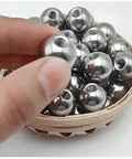 Close-up of stainless steel threaded piercing ball (M8) with 15–60 mm diameter, silver, in a basket