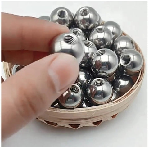 Close-up of stainless steel threaded piercing ball (M8) with 15–60 mm diameter, silver, in a basket