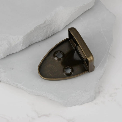 2 Pcs Bronze 90 Degree Flip Hinges For Guitar Cases And Piano Cabinets Music Box Hardware with mounting holes on a stone surface.