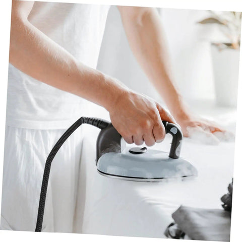 Person using electric iron connected with High Temperature Steam Iron Replacement Hose With Easy Install No Fuss Lightweight Flexible Tube