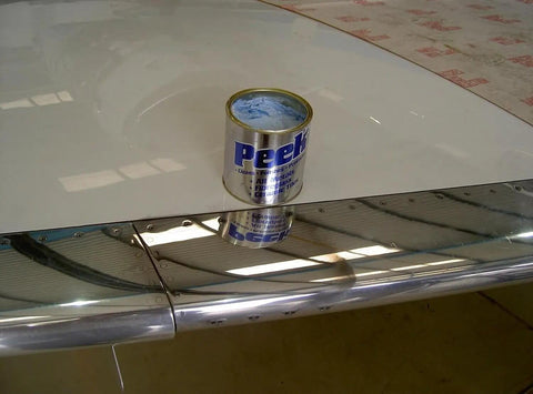 Multipurpose All In One Metal Cleaner And Polish For Chrome Aluminum Silverware Glass And Fiberglass Cleans Shines And Protects All Metals Fiberglass And Acrylics Home And Industrial Use 1000ml Can shown on polished surface.