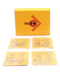 Front view of TACSHIM .276 pivot pin and take-down pin shim kit; yellow box with TACSHIM logo and fourteen metal shims