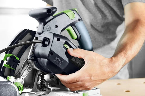 Person adjusting Plunge Cut Saw With Scoring Function TSV 60 KEB F Plus Diamond Scoring Blade for precision woodworking.