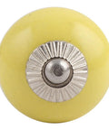 Top Quality Solid Yellow Ceramic Drawer Knobs One Hundred Piece Set For Kitchen Cabinets And Dresser Drawers Slick Modern Style That Packs Badass Durability And Is Super Easy To Install For Quick Room Glow Up - close-up view of a yellow ceramic knob with silver detail.