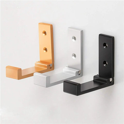 Three wall-mounted hangers in gold, silver, and black. Folding Coat Hooks 5 Pack Wall Mounted Hangers For Coats, Towels, Bags And Fitness Gear.