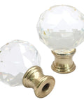 Sleek Clear Crystal Lamp Finials Two Pack With Polished Gold Screw Bases displaying two geometric glass knobs with brass bases.