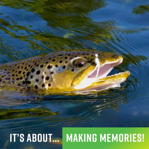 Brown trout in freshwater with mouth open, biting lure, text overlay 'It's about making memories!'