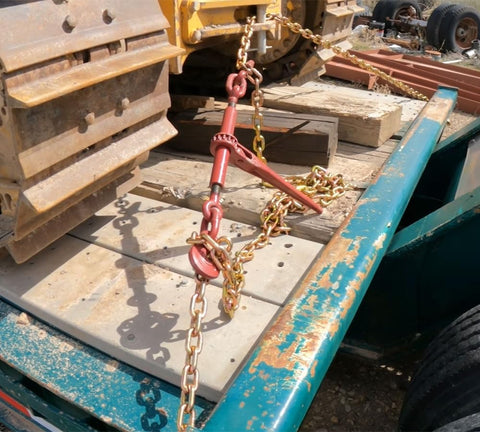 Heavy-Duty Grade 70 Transport Chain And Binder Kit with Four Three-Eighths Inch by Twenty-Foot Chains securing cargo on a truck