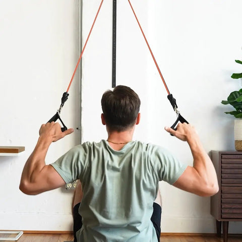 Person using Space Saving Wall Mount Gym Anchor System With 4 Stackable Resistance Bands Adjustable Rail Car for workouts.