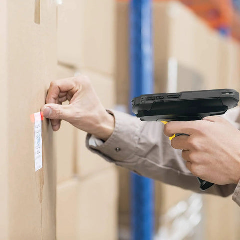 Trigger Grip Handle For TC51 Series Handheld Barcode Scanner used by person to scan package label in warehouse setting