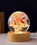 Red Daisy Flower Glass Ball Night Light With Wood Base 2.4 Inch Ambient Lamp Resin Crystal Globe in warm glow.