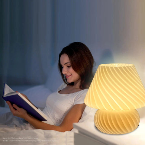 Woman reading by Swirl Mushroom Lamp With Vintage Striped Murano Glass on bedside, emitting warm white light, 9.9 inch tall