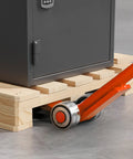 Close-up of Workhorse Pry Lever Bar with Three Ton Load Capacity lifting pallet with orange steel handle and 2.8 inch wheels.