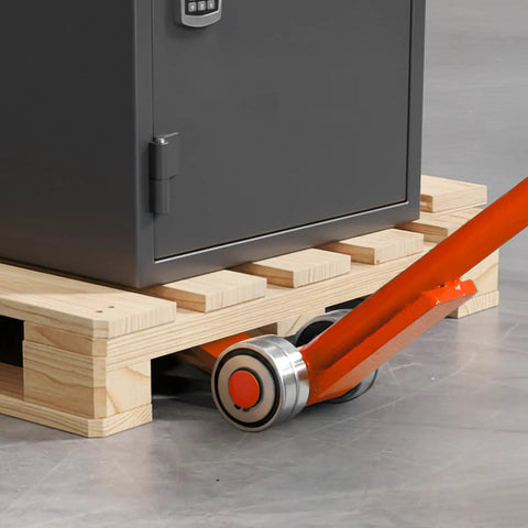 Close-up of Workhorse Pry Lever Bar with Three Ton Load Capacity lifting pallet with orange steel handle and 2.8 inch wheels.