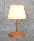 Cordless USB Rechargeable Table Lamp With 4000mAh Battery, 2700K Warm LED, 15in wood grain base, PE shade, on stone surface.