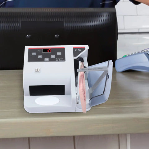 Fast Money Counter With LCD Display And Counterfeit Detection on a wooden counter